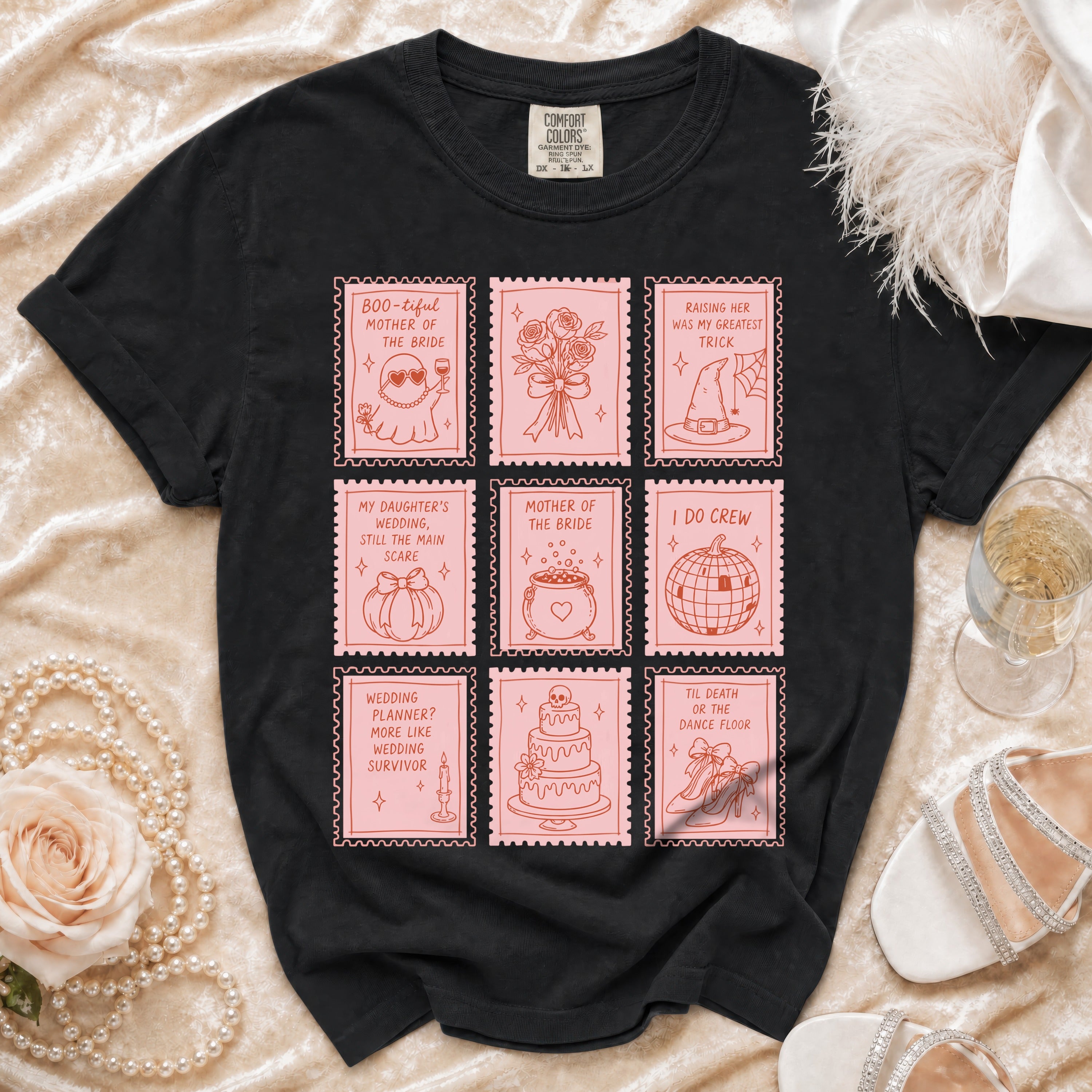 Black t-shirt with pink graphic of nine postage stamps featuring wedding and Halloween themed illustrations.