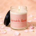 Lit candle with pink label reading "Gaywatch: Married Season Finale: The Vows" surrounded by petals.
