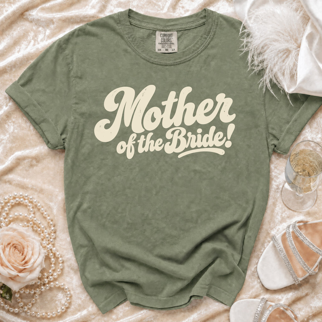 Green t-shirt with cream text "Mother of the Bride!" on textured fabric.