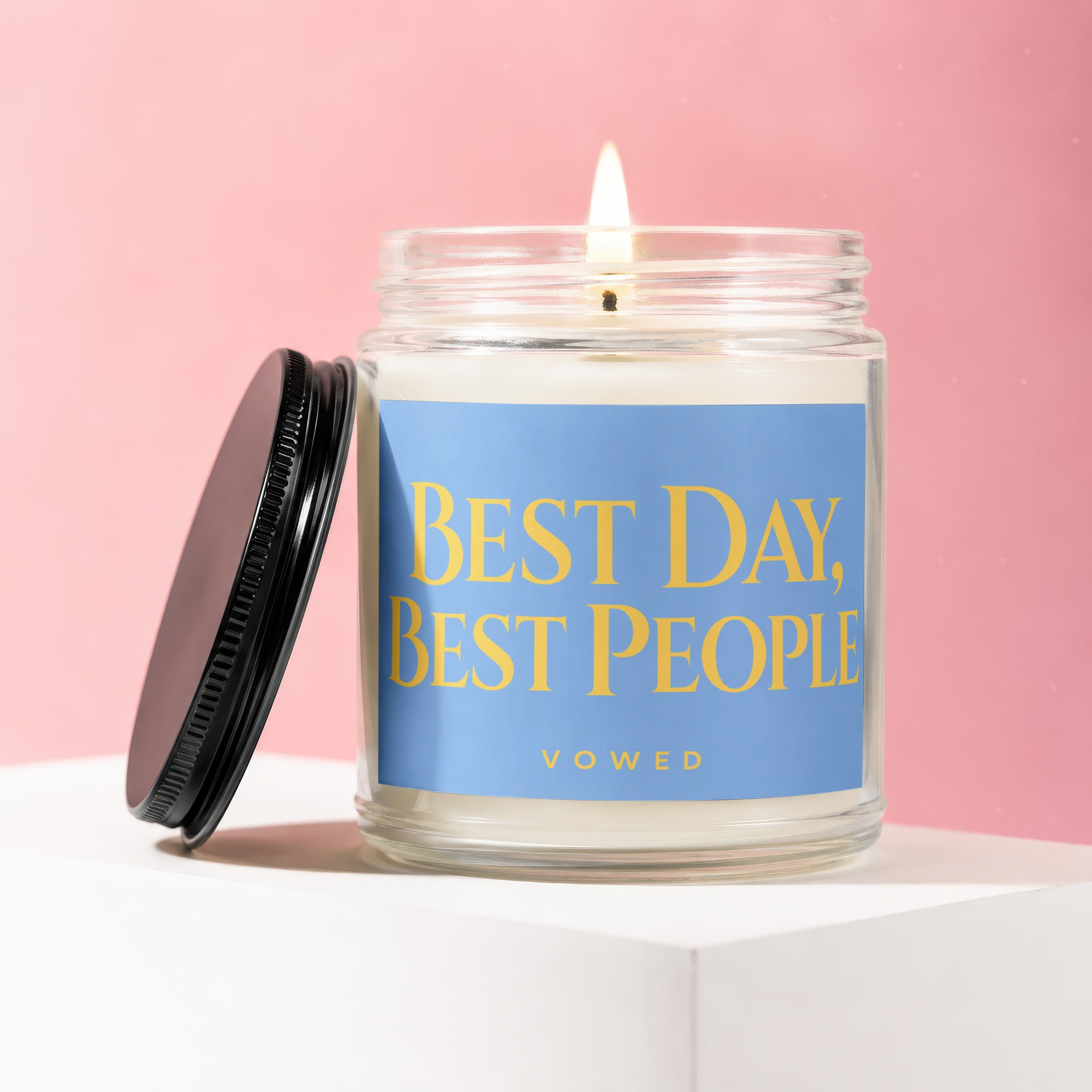 Lit candle in glass jar with lid off, text reads "BEST DAY, BEST PEOPLE VOWED".