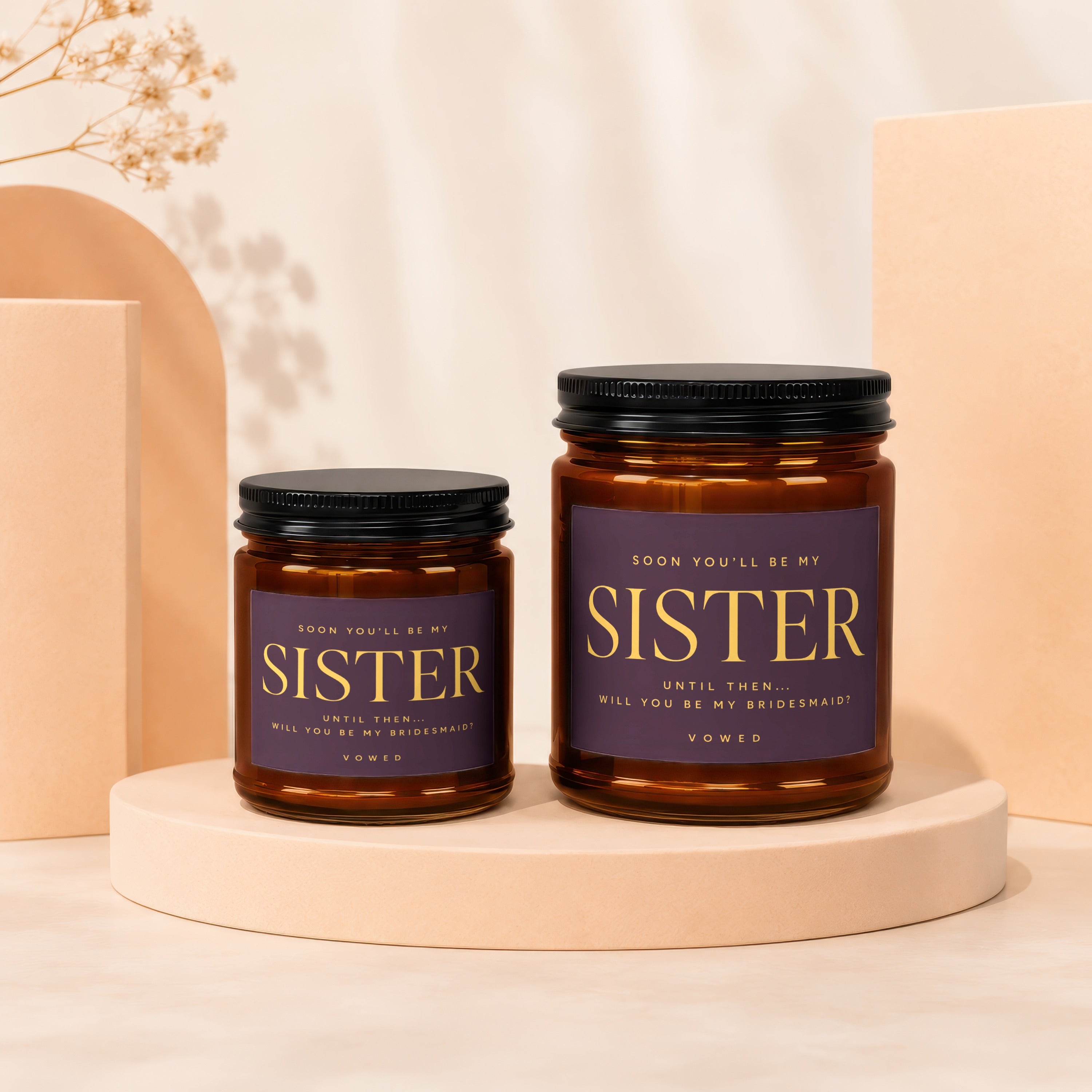 Two brown glass jars with black lids feature purple labels reading "Sister" and "Will you be my bridesmaid?".