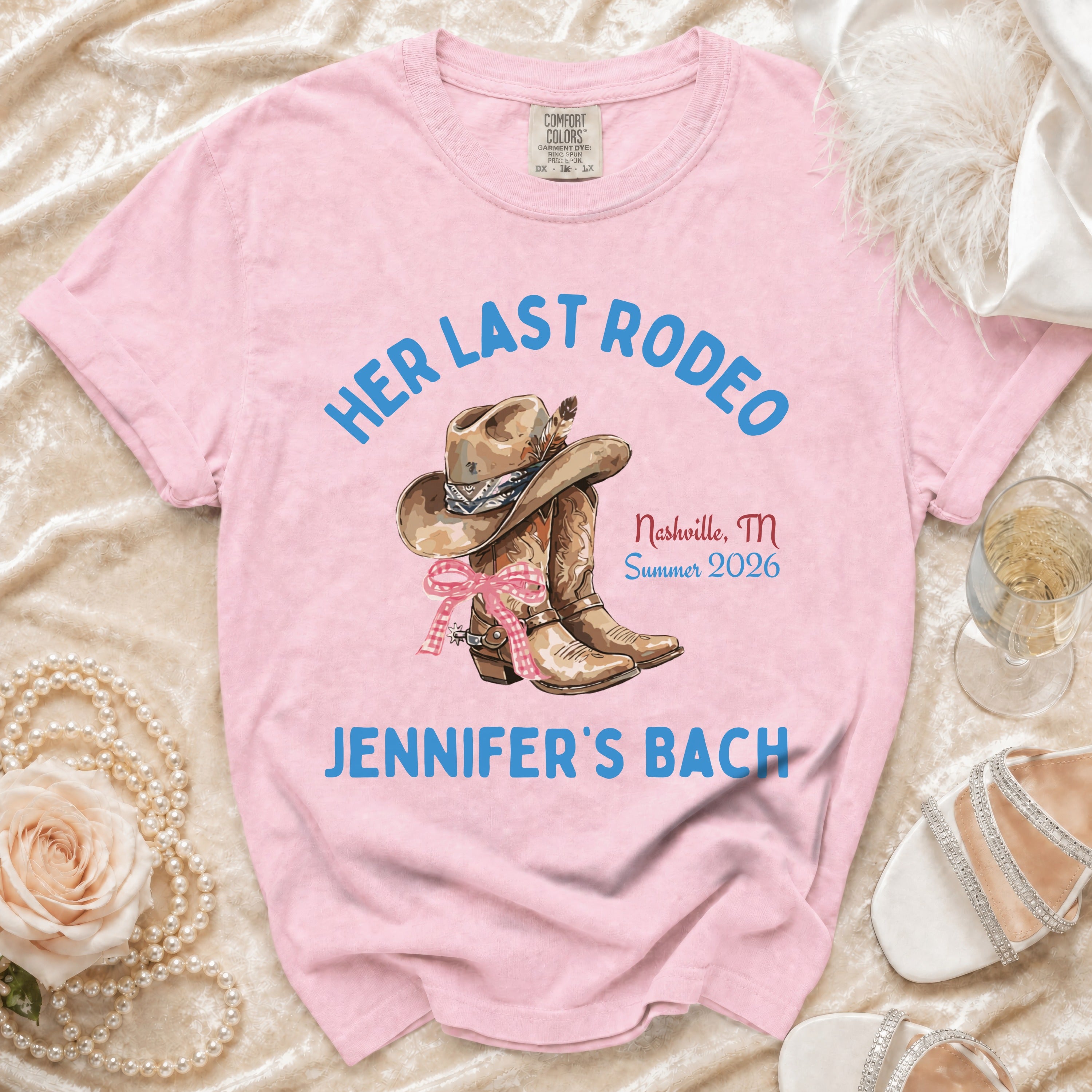 Pink t-shirt with "Her Last Rodeo" text, cowboy hat, boots, and wedding details.