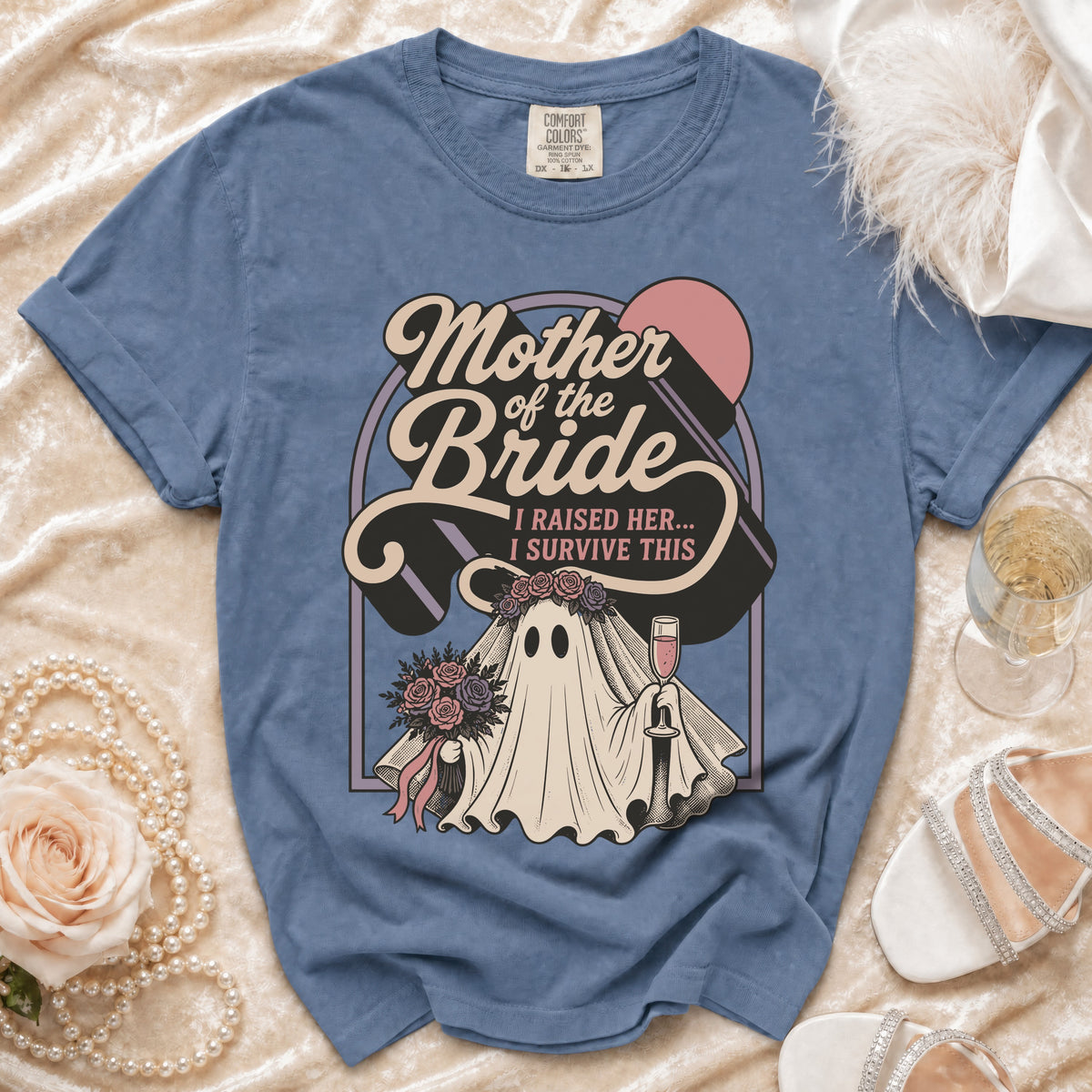 Blue t-shirt with "Mother of the Bride I Raised Her I Survive This" ghost graphic.