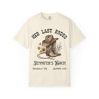 Cream t-shirt with cowboy boots, hat, rope, and "Her Last Rodeo" text.