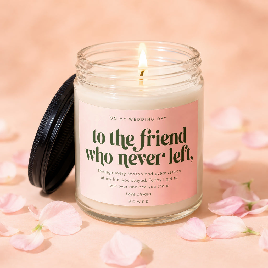Glass candle with pink label reading, "To the friend who never left. Love always."
