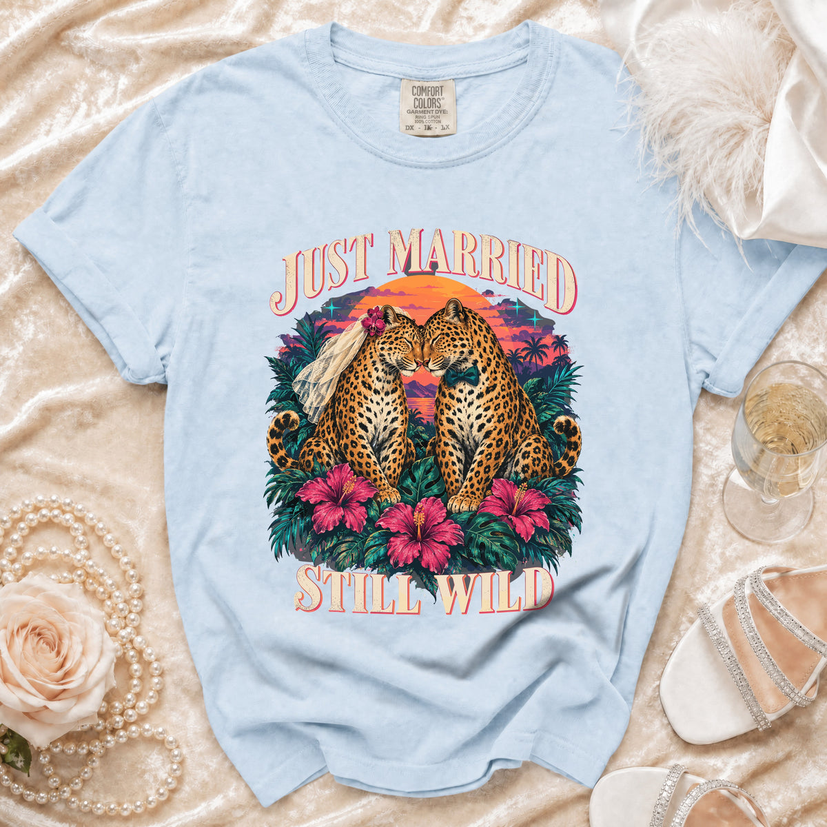 Light blue t-shirt with leopards wearing veil and bow tie, text "JUST MARRIED STILL WILD".