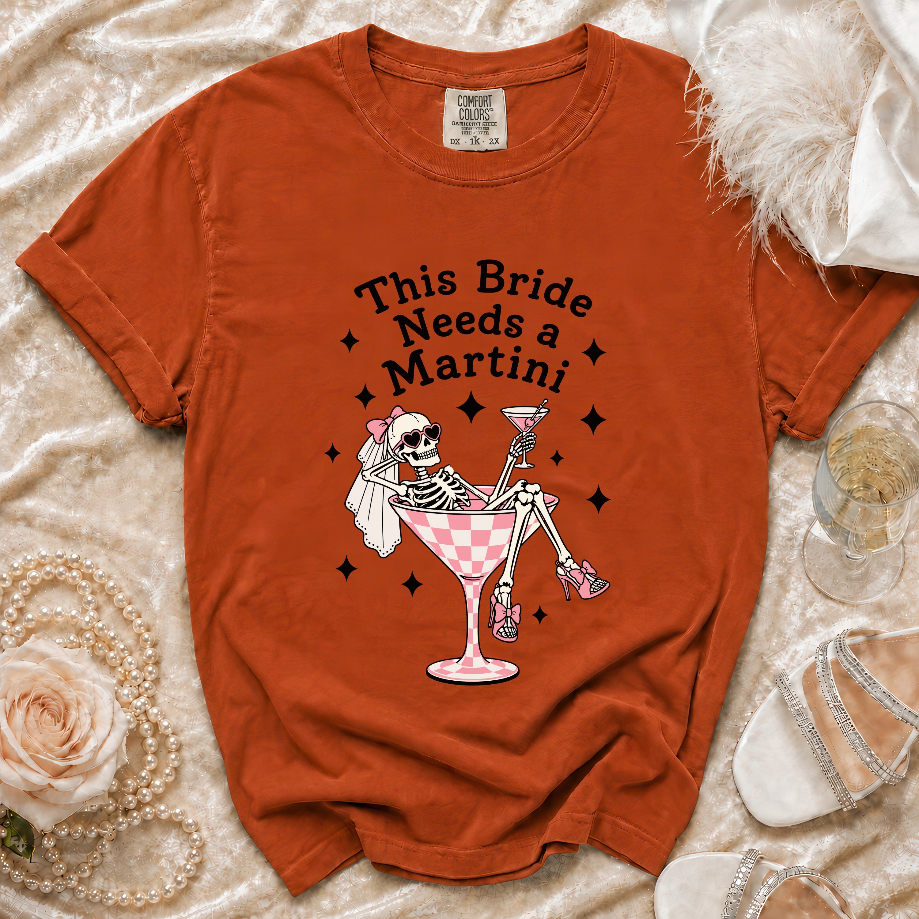Orange t-shirt with text "This Bride Needs a Martini" and skeleton graphic.