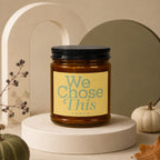 Amber candle with label reading "We Chose This vowed".