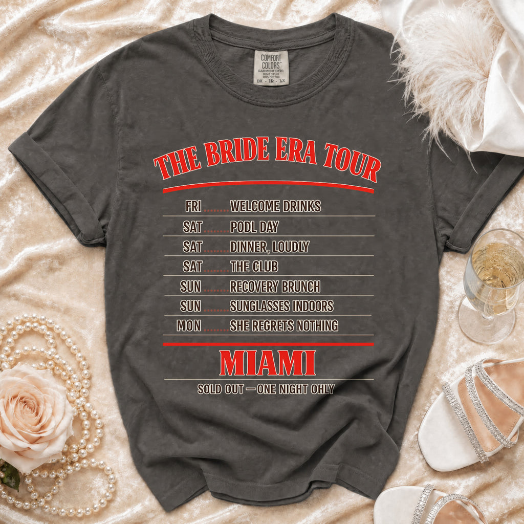 Dark gray t-shirt with "The Bride Era Tour Miami" text and a weekend itinerary.