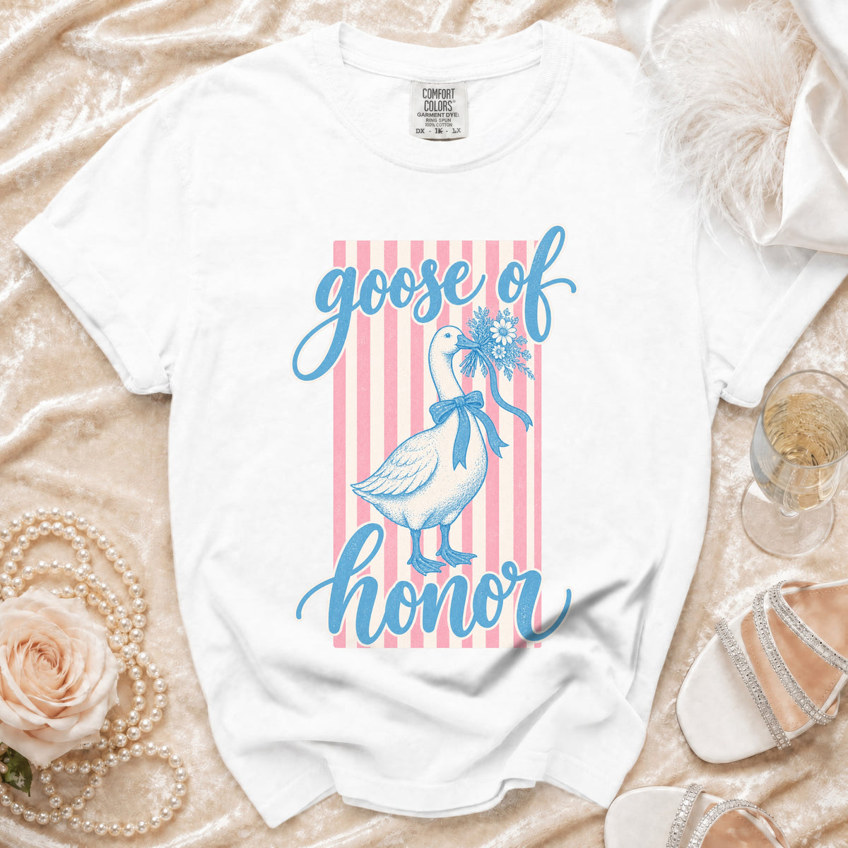 White t-shirt with "goose of honor" text and goose illustration on pink stripes.