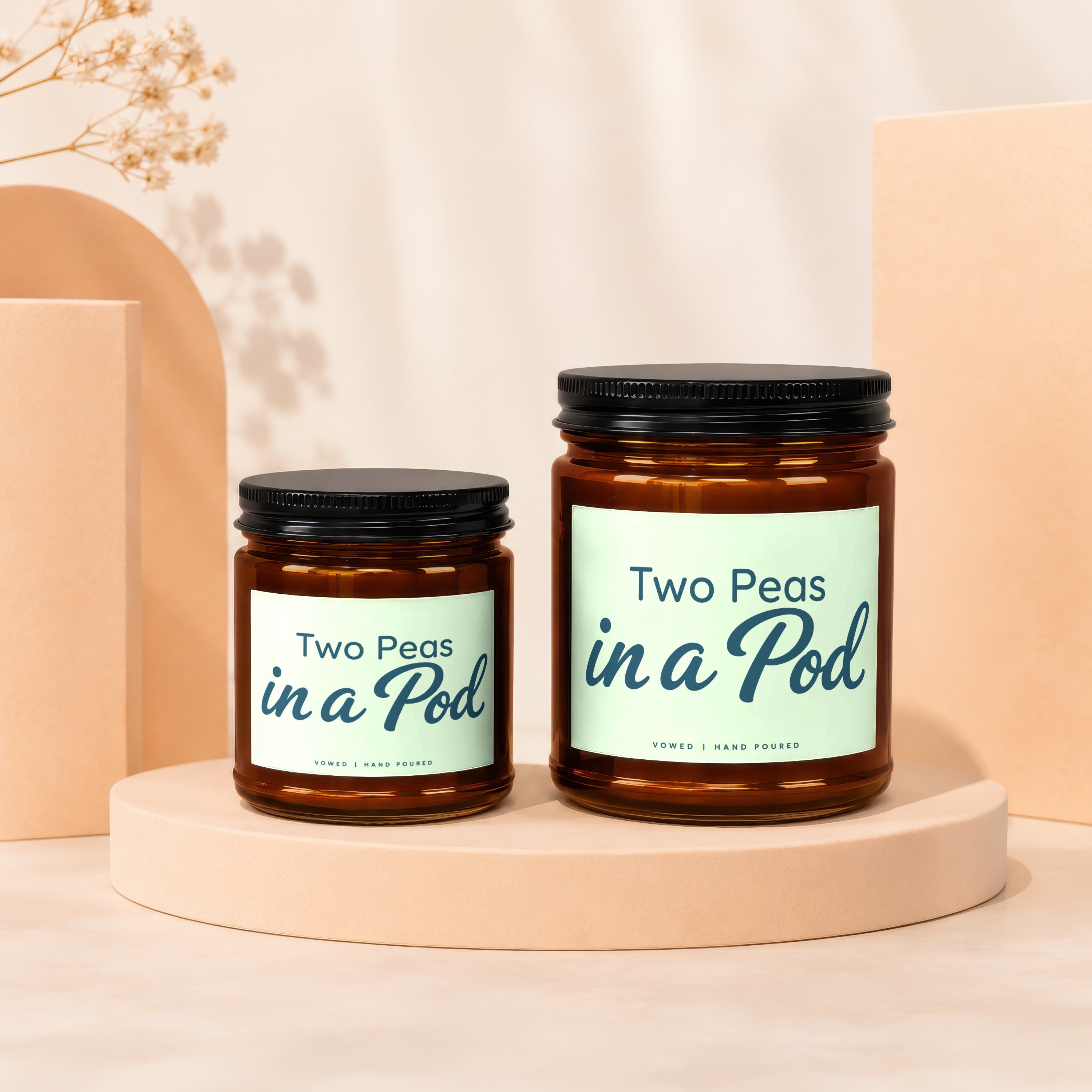 Two amber glass candles labeled "Two Peas in a Pod".