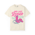 Cream t-shirt with pink "HER LAST Rodeo" text, cowboy boot, hat, and lasso.