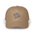 Tan baseball cap featuring embroidered blue cursive text that reads Wild Wild on the front panel.