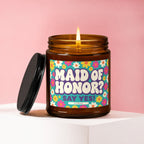 Amber candle with "MAID OF HONOR? SAY YES! VOWED" on a retro floral label.