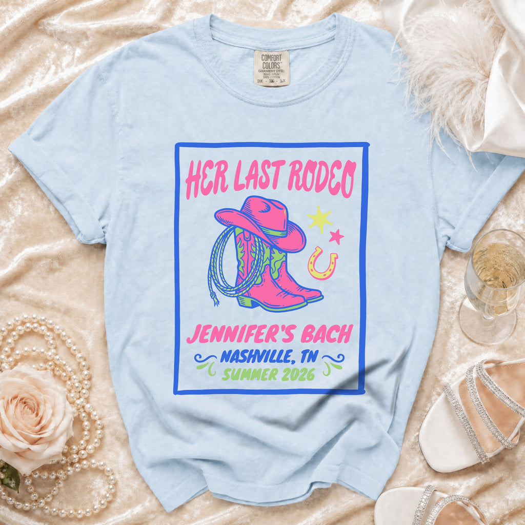 Light blue t-shirt with "Her Last Rodeo Jennifer's Bach Nashville Summer 2026" text and graphics.