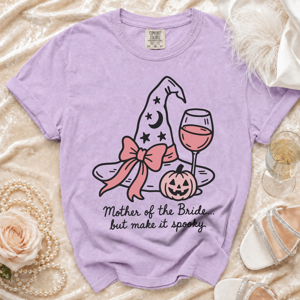 Purple t-shirt with spooky witch hat, pumpkin, and wine glass graphic.