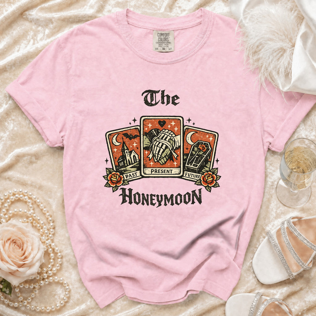 Pink t-shirt with "The Honeymoon" tarot card graphic of past, present, and future.