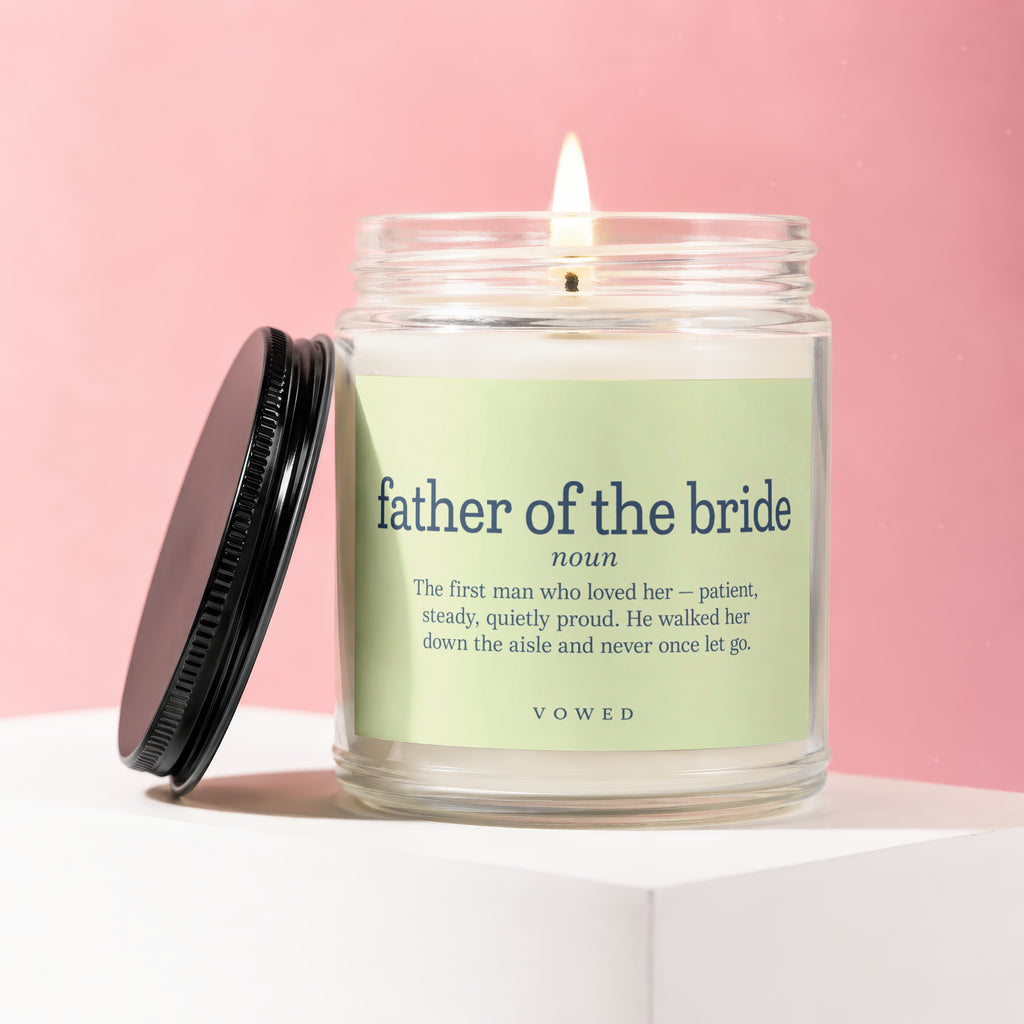 Candle with label "father of the bride" and definition on pink background.