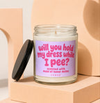 Glass jar candle with pink text asking "will you hold my dress while I pee?".