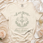 Cream t-shirt featuring green text reading Last Quest Before the Dress, Olivia’s Bachelorette, Asheville, NC.