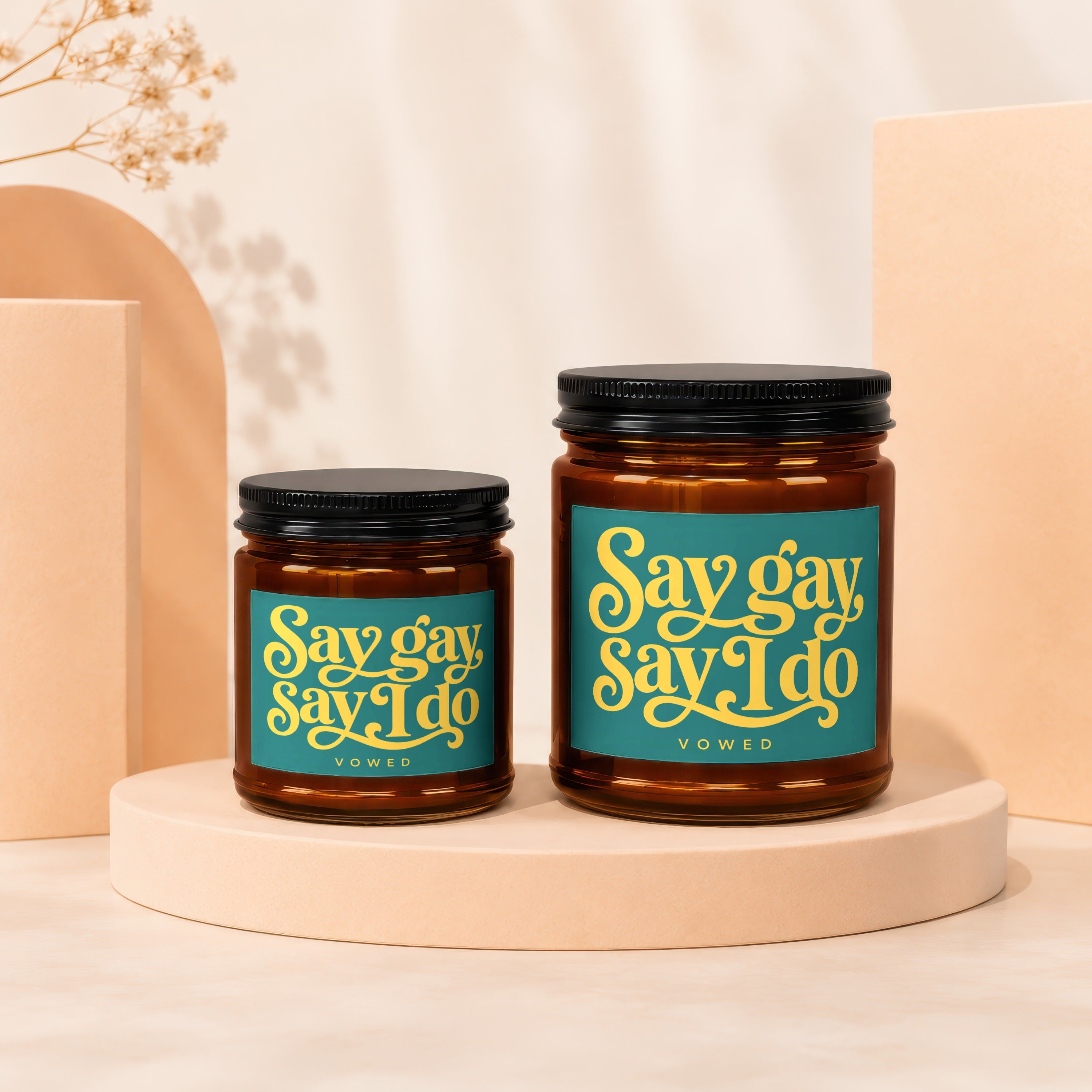 Two amber glass jars with black lids, one larger than the other.