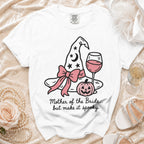 White t-shirt with witch hat, pumpkin, wine glass, and text "Mother of the Bride... but make it spooky."