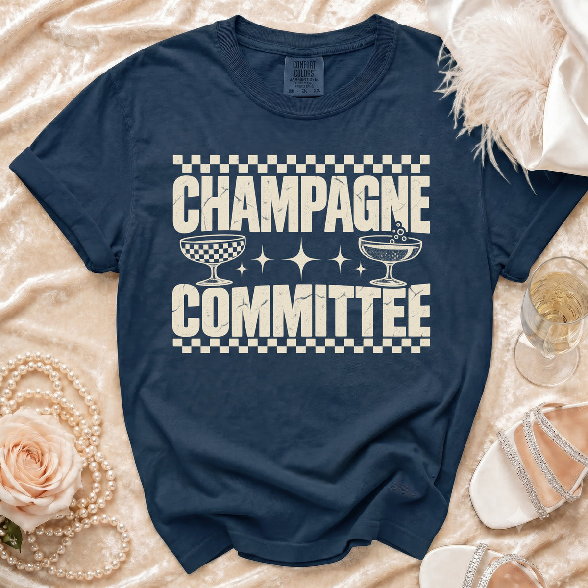 Navy t-shirt with distressed text "CHAMPAGNE COMMITTEE" and champagne glasses.