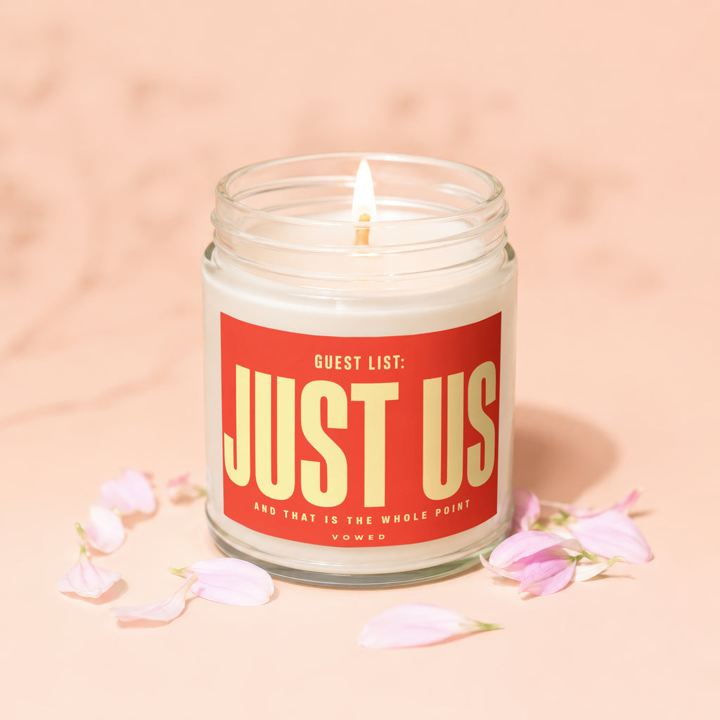 Scented candle with label "Guest List: Just Us and that is the whole point Vowed".