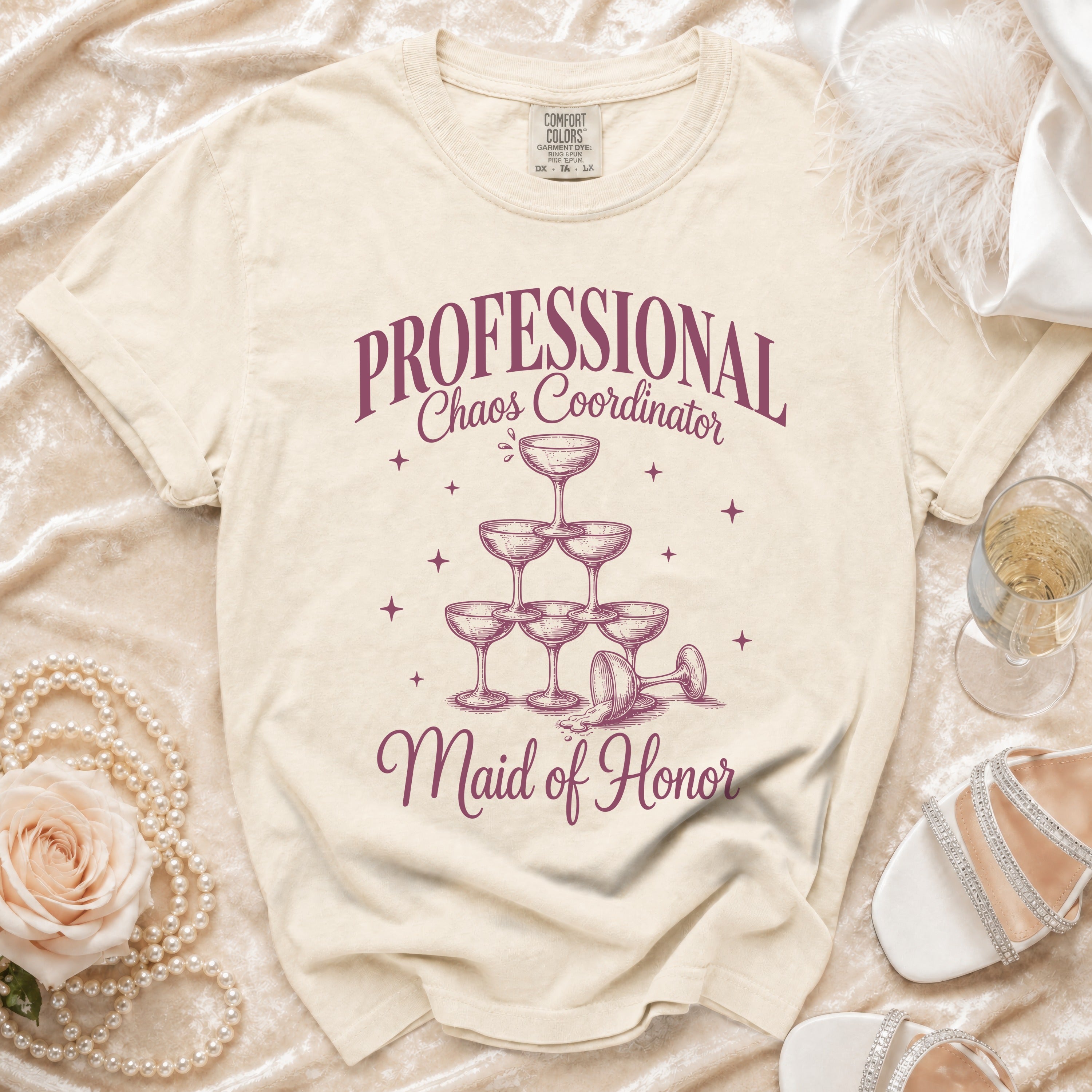 Shirt with "PROFESSIONAL Chaos Coordinator Maid of Honor" text and champagne glass pyramid graphic.