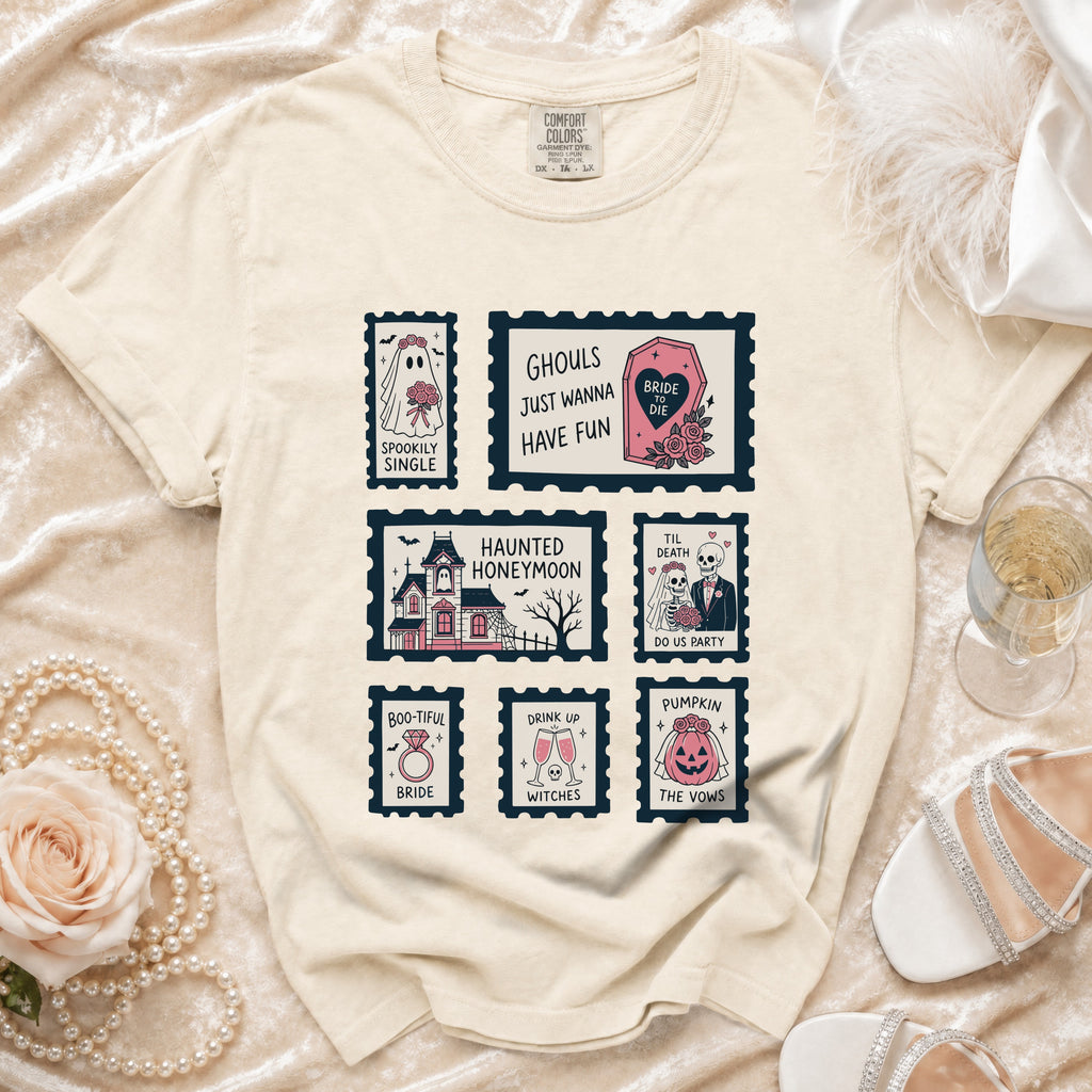 Cream t-shirt with postage stamp graphics: "Spookily Single," "Ghouls Just Wanna Have Fun," "Haunted Honeymoon," "Til Death Do Us Party," "Boo-tiful Bride," "Drink Up Witches," and "Pumpkin the Vows."