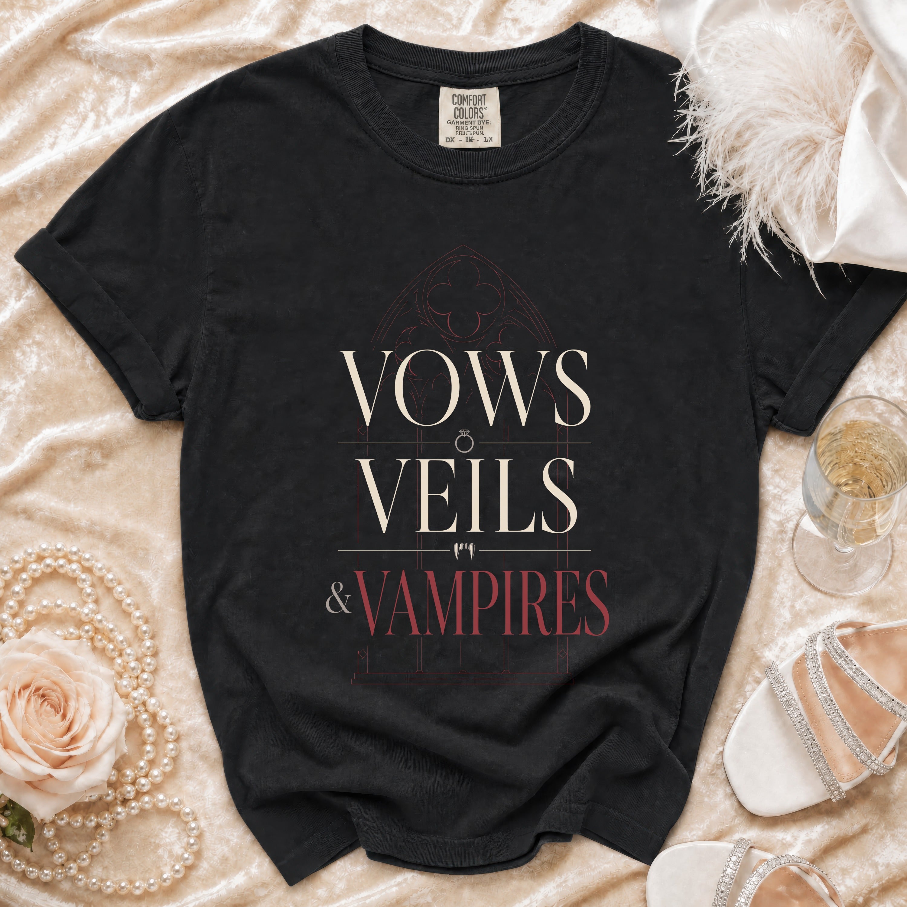 Black t-shirt with "Vows Veils & Vampires" text and gothic window design.