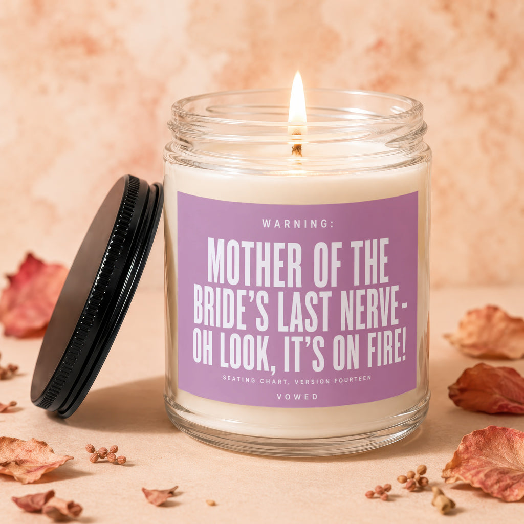 Candle with purple label reading "Mother of the Bride's Last Nerve - Oh Look, It's On Fire!"