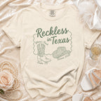 Comfort Colors t-shirt with "Reckless in Texas" design for Olivia's Bach.