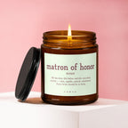 Amber jar candle with a lit flame and "Matron of Honor" definition label.