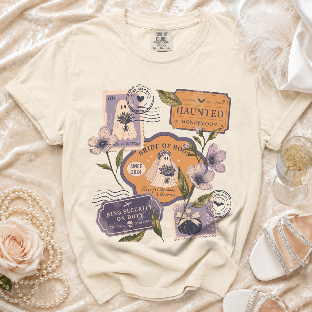 Cream t-shirt with "Bride of Boos" graphic featuring ghosts, stamps, and Halloween wedding text.