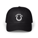Black dad hat featuring a white embroidered horseshoe and the text SADDLIN' UP on the front panel.