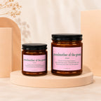 Two amber glass candles with pink labels reading "grandmother of the groom".