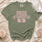 Bride of Frankenstein graphic tee with a distressed pink design.