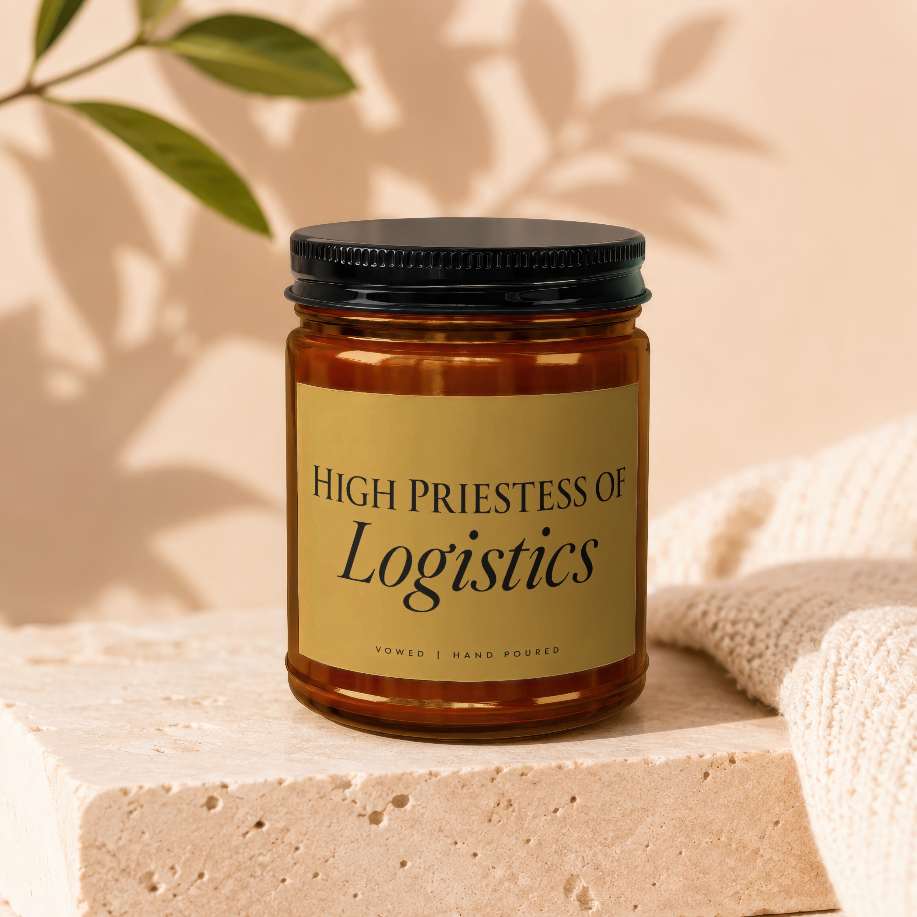 Amber jar candle labeled "High Priestess of Logistics" with "Vowed | Hand Poured".