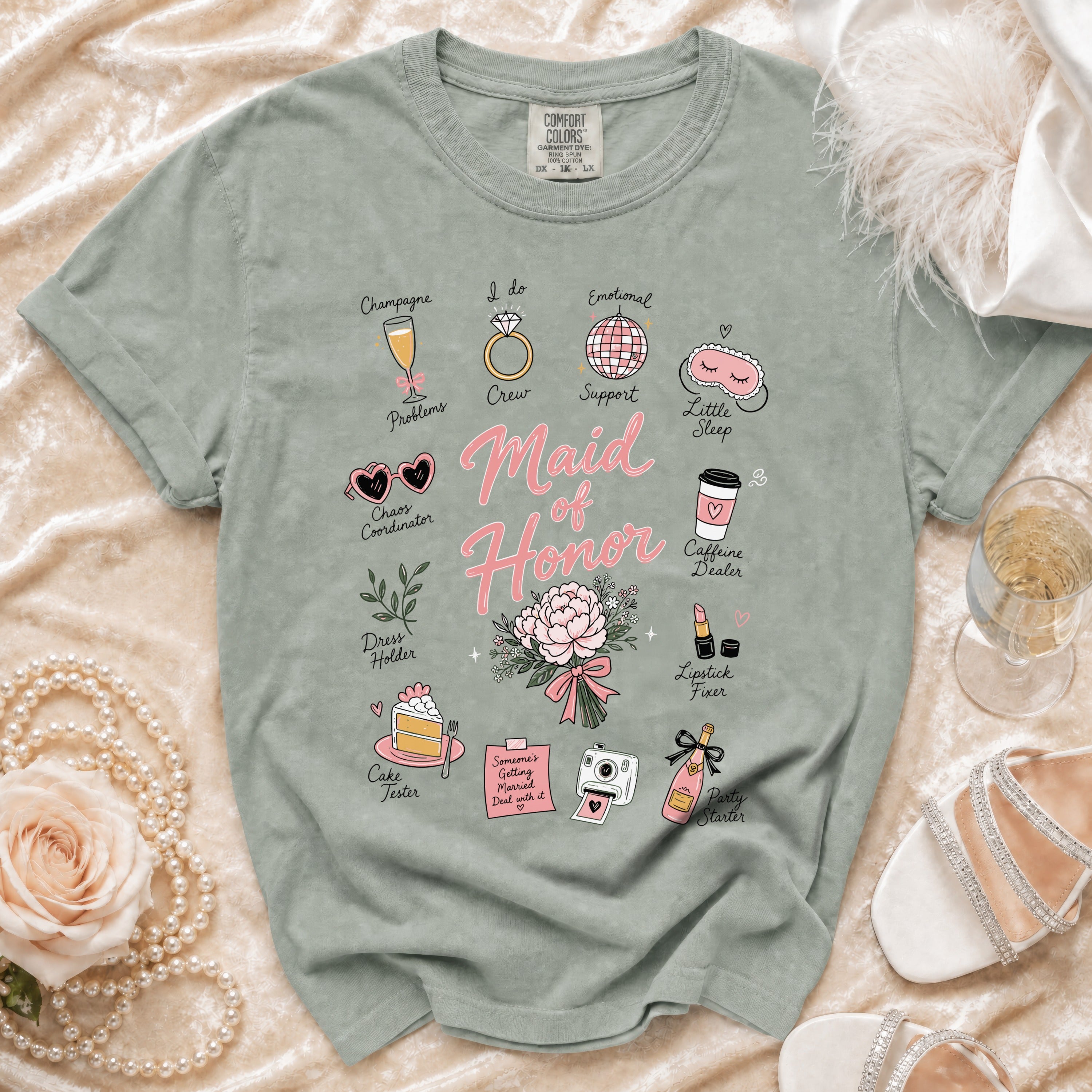 Muted green t-shirt with "Maid of Honor" and wedding-themed illustrations.