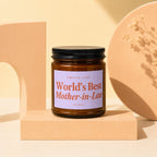 Amber jar candle with lavender label reading, "Smells Like World's Best Mother-in-Law".