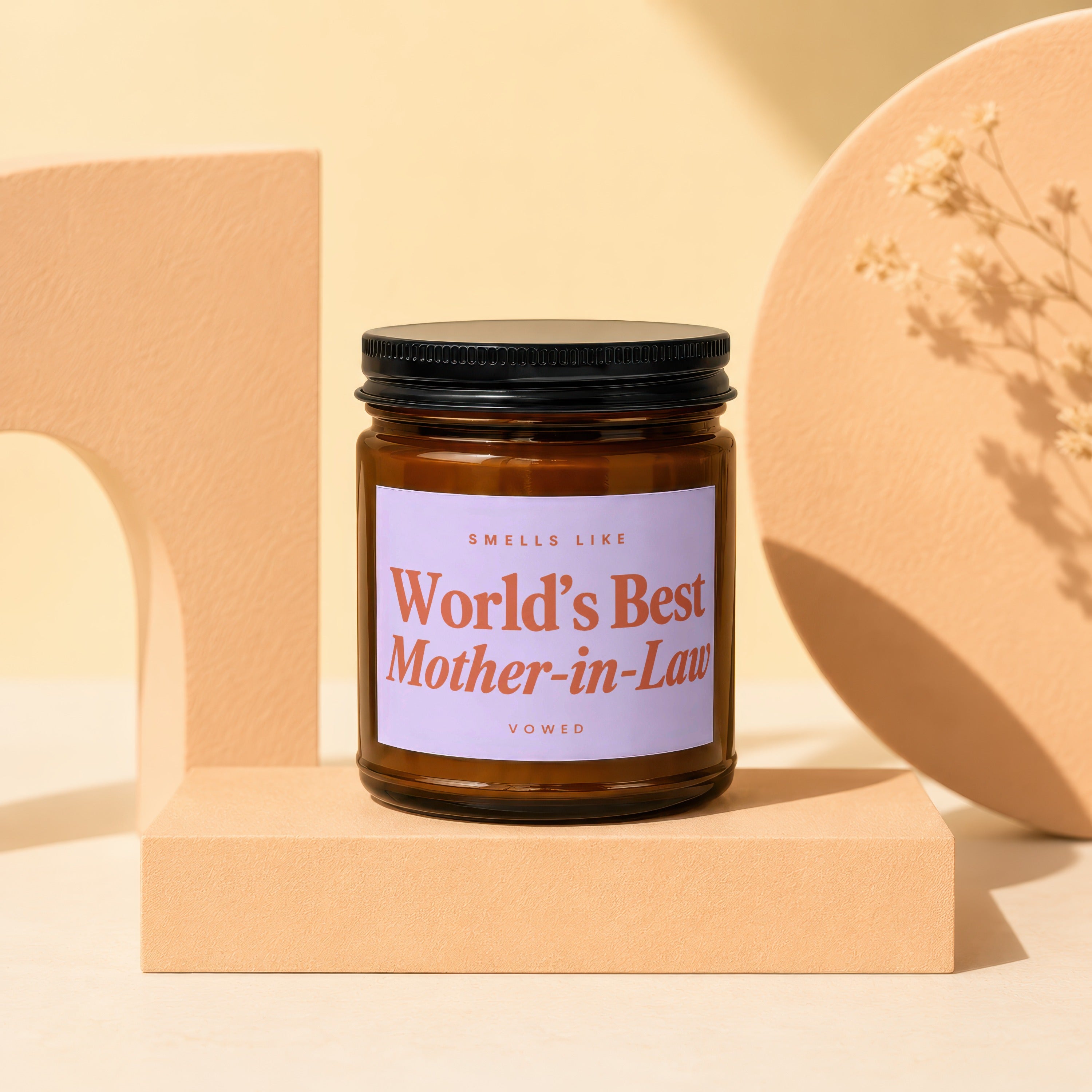 Amber jar candle with lavender label reading, "Smells Like World's Best Mother-in-Law".