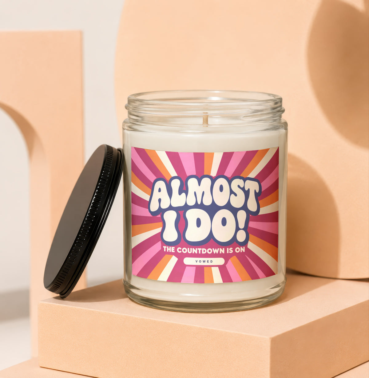 Glass candle with "Almost I Do! The Countdown Is On" label and black lid.