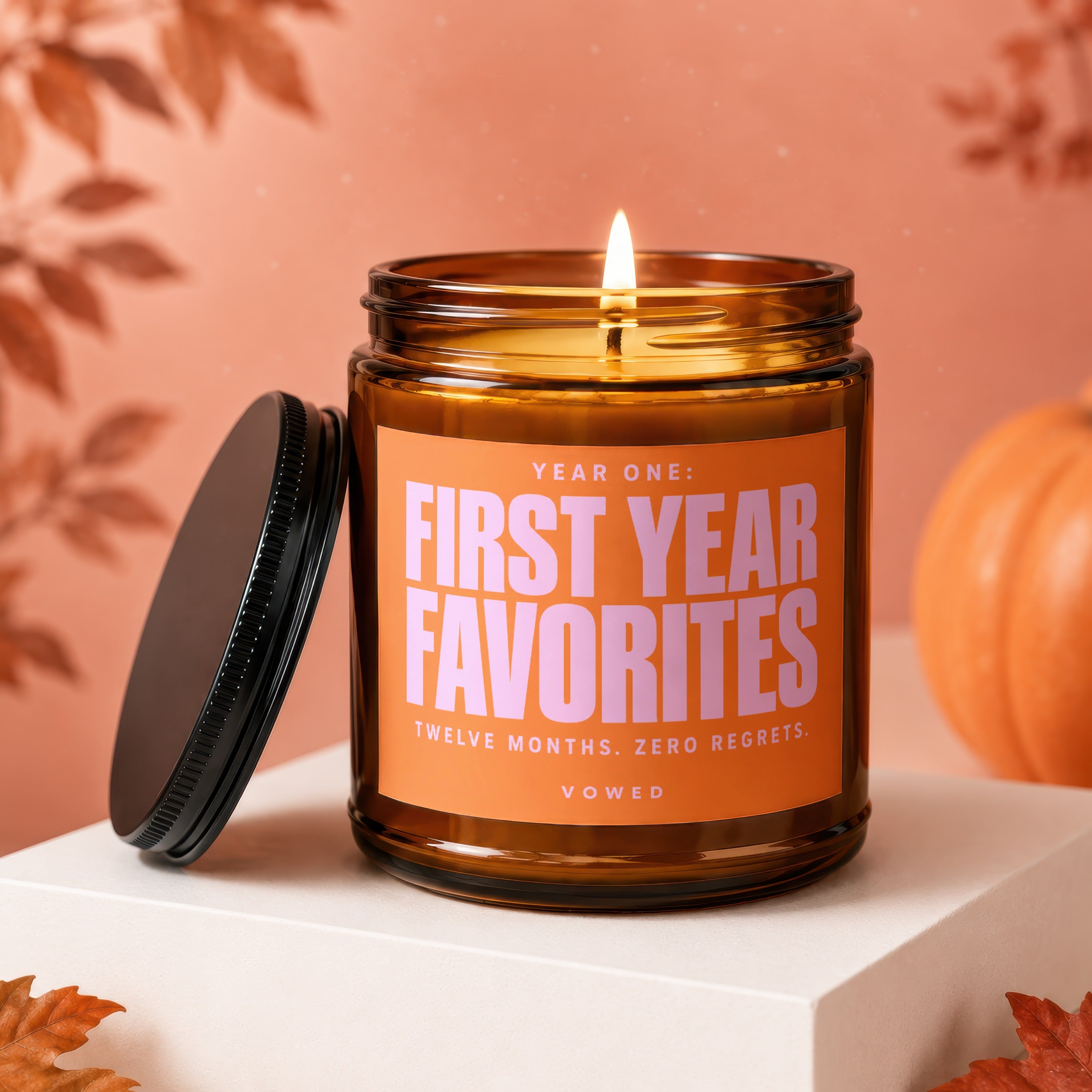 Amber candle with orange label reading "Year One: First Year Favorites. Twelve Months. Zero Regrets."