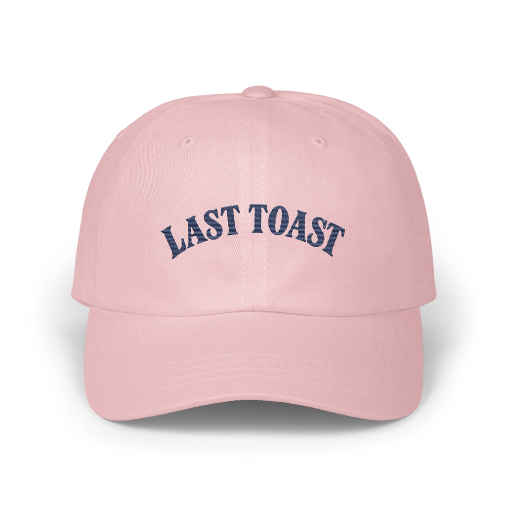 Pink baseball cap with navy blue "LAST TOAST" embroidery.