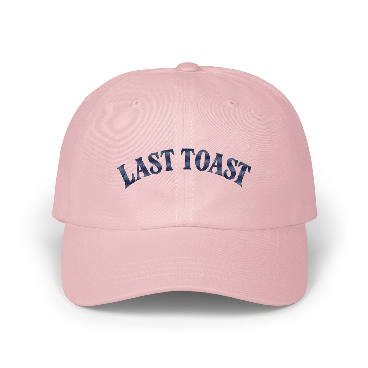 Pink baseball cap with navy blue "LAST TOAST" embroidery.