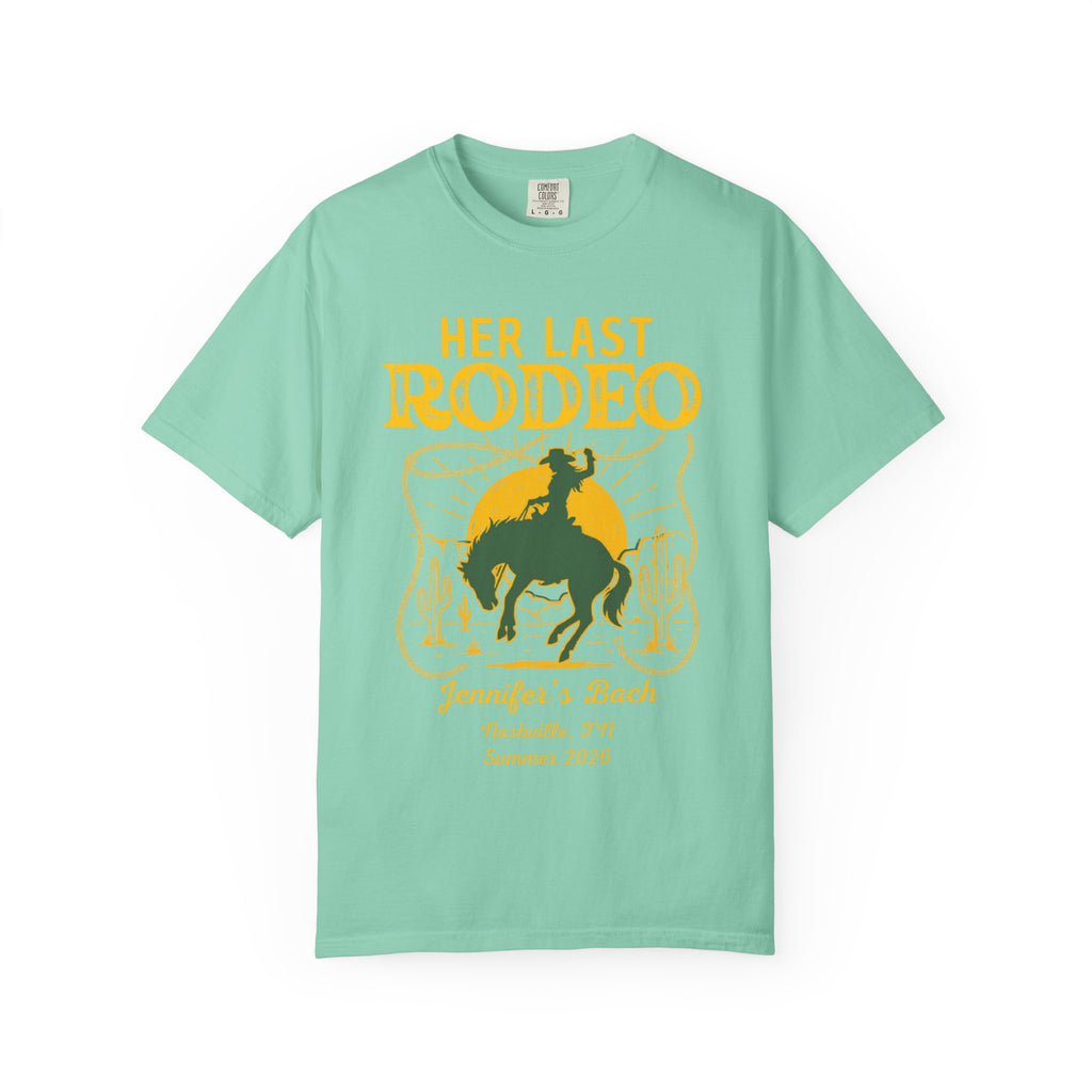Her Last Rodeo text with cowboy and cactus design on teal t-shirt.