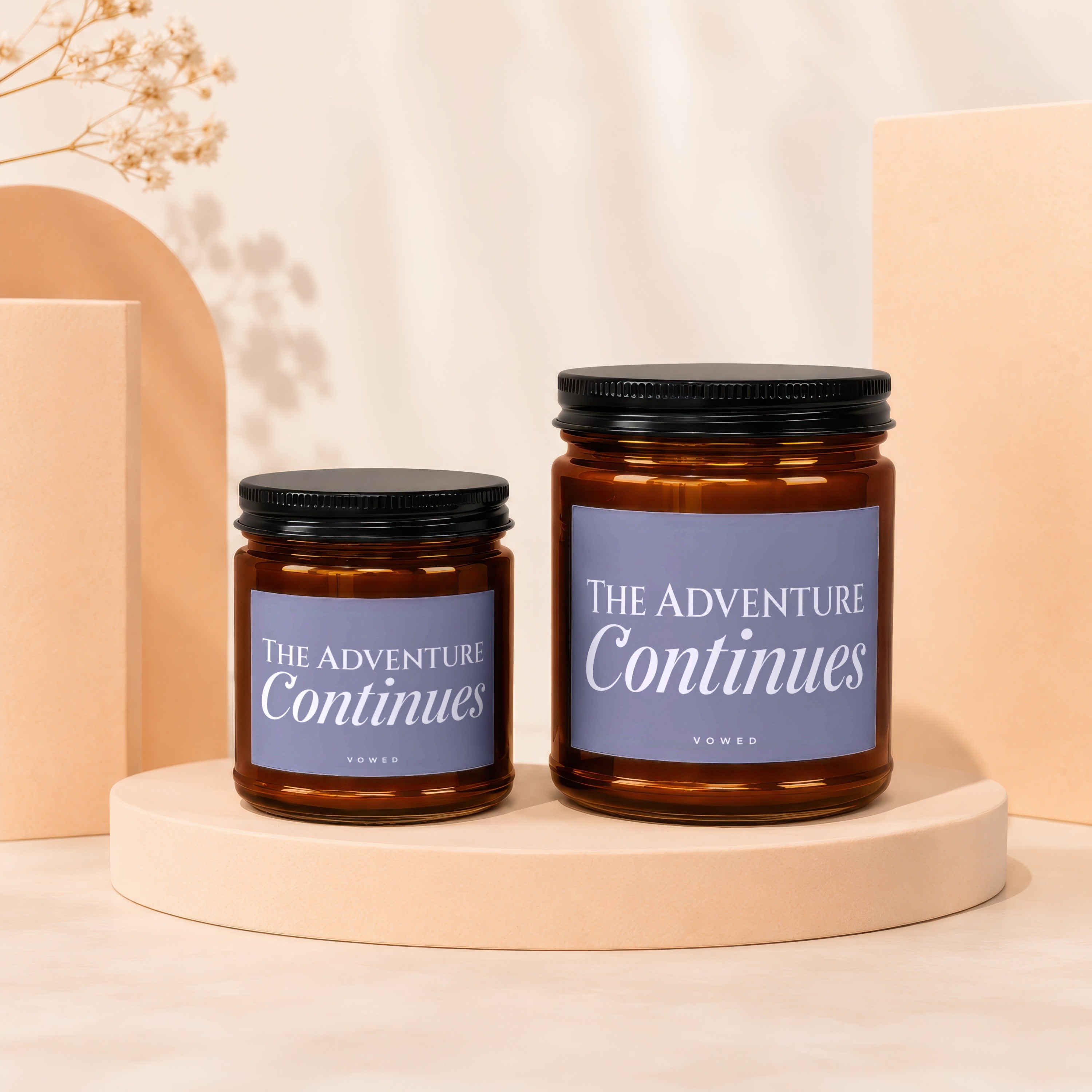 Two amber glass jars with black lids, labels read "The Adventure Continues".