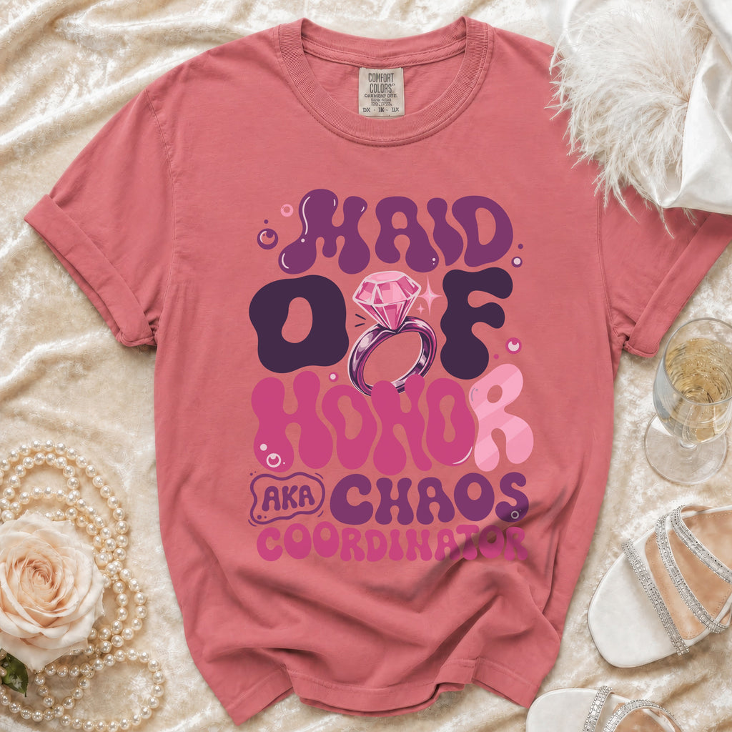 Maid of Honor AKA Chaos Coordinator text with ring and diamond graphic on pink t-shirt.