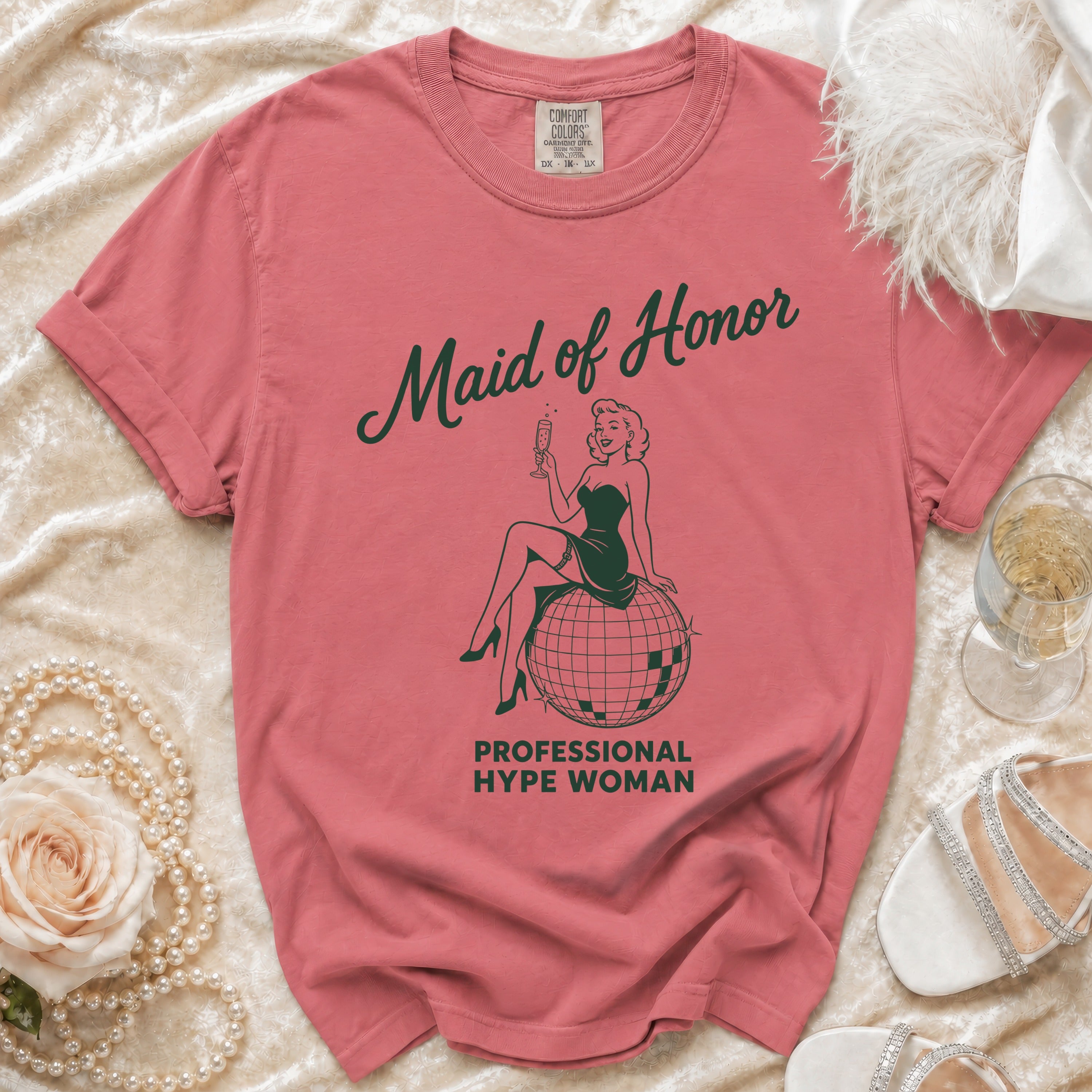 T-shirt with "Maid of Honor Professional Hype Woman" text and retro illustration.